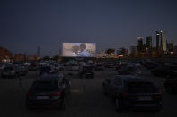 Moviegoers watch the movie "Grease" at the Autocine Madrid Race drive-in cinema during the coronavirus outbreak in Madrid, Spain, Thursday, June 4, 2020.(AP Photo/Bernat Armangue)