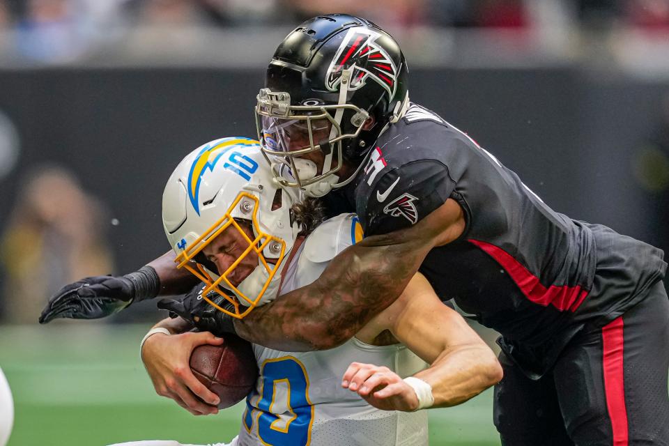 Former Chicago Bears and Atlanta Falcons linebacker Mykal Walker sacks Los Angeles Chargers quarterback Justin Herbert during a game on Nov. 6, 2022 at Mercedes-Benz Stadium