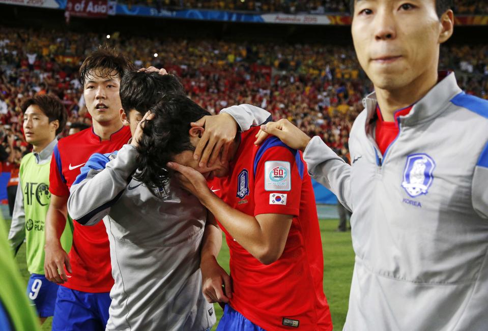 South Korea's Son is consoled by team mates after their Asian Cup final soccer loss to Australia in Sydney