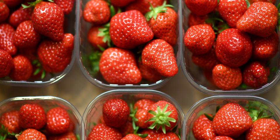 strawberries in a half-dozen containers