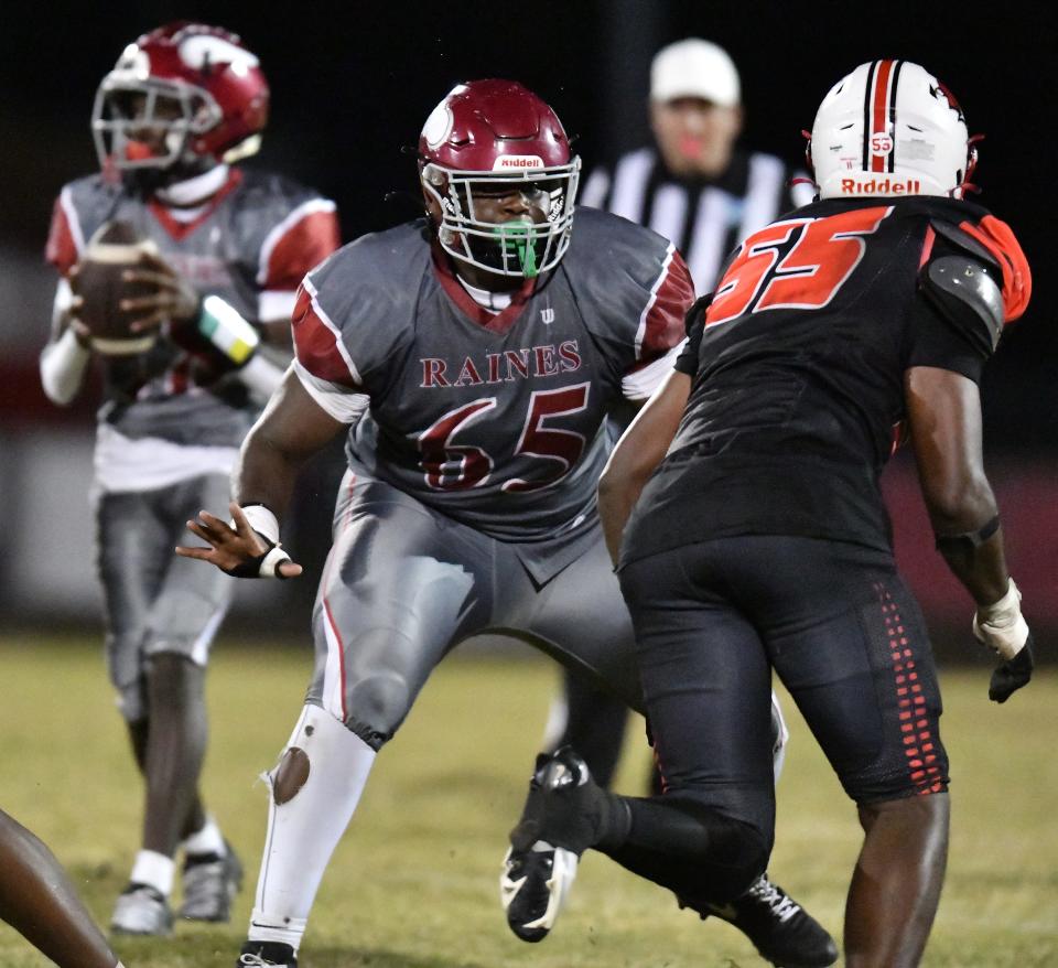 Raines Vikings Solomon Thomas (65) protects his quarterback from Andrew Jackson Tigers King Massey (55) during The Raines High School Vikings traveled to the Andrew Jackson Tigers home field for their football matchup Thursday, October 26, 2023. The Vikings led 28 to 10 at the end of the half and came away with a 40 to 8 victory.