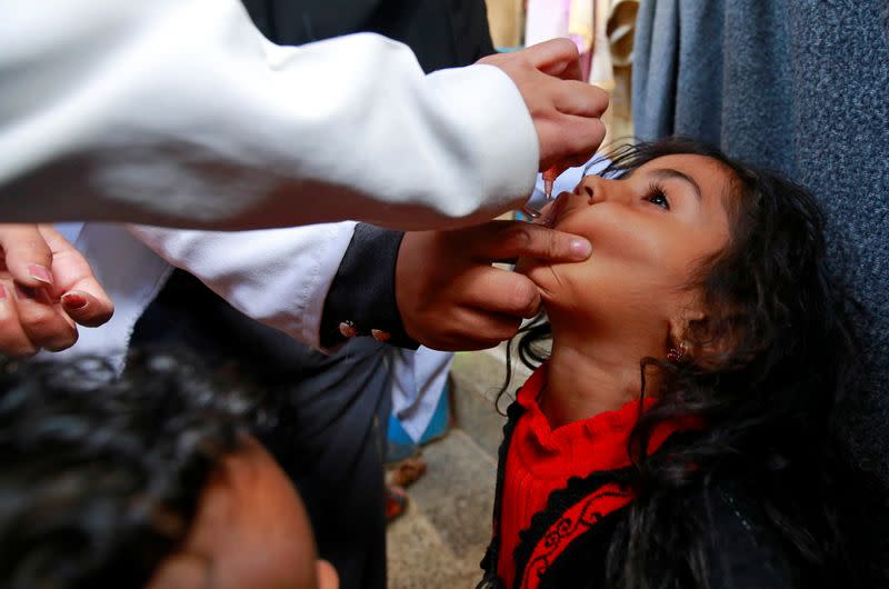 Girl receives a polio vaccine during a three-day immunization campaign in Sanaa