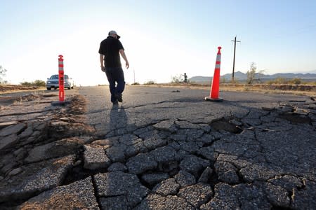 Fissures that opened up under a highway during a powerful earthquake that struck Southern California are seen near the city of Ridgecrest