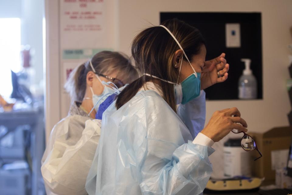 Chaplain Anne Dauchy, left, comforts Dr. Marwa Kilani in the ICU at Providence Holy Cross Medical Center.