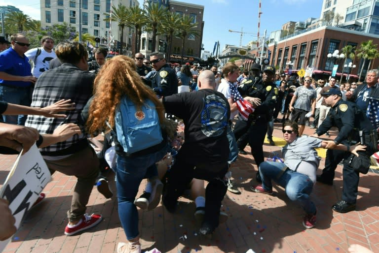 Protesters and supporters of Republican presidential candidate Donald Trump clash during a rally outside Trump's event in San Diego, California, on May 27, 2016