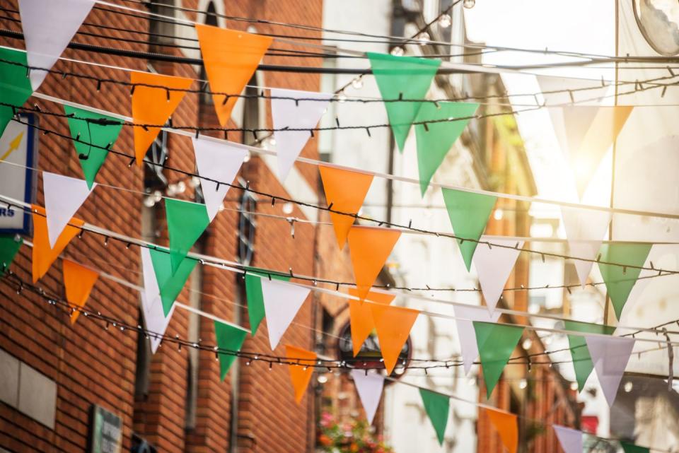 garland with irish flag colors in a street of dublin, ireland saint patrick day celebration concept
