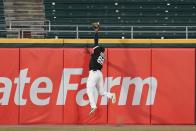 <p>Chicago White Sox outfielder Luis Robert makes a catch in action during an exhibition game between the Chicago White Sox and the Milwaukee Brewers at Guaranteed Rate Field on July 22 in Chicago.</p>