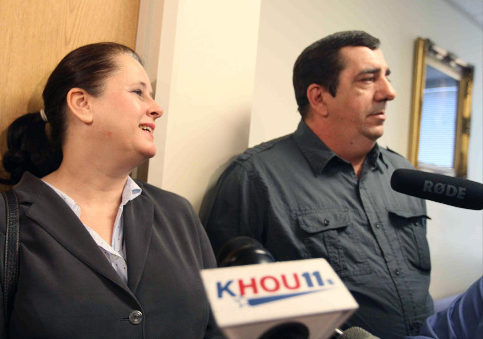 CORRECTS TO JUDGE HAMILTON, NOT COLLINS IN SECOND SENTENCE - Colleen and Boby Middleton, the parents of victim Robert Middleton, speak to the media after hearing regarding Don Willburn Collins at the 359th Judicial District Court with Judge Kathleen Hamilton on Thursday, March 6, 2014, in Conroe, Texas. Collins, now 28, accused of dousing Middleton with gasoline and setting him on fire in 1998 when he was a teenager, can be tried as an adult for murder after the victim died from his burns nearly 13 years later, Judge Hamilton ruled Thursday. (AP Photo/ The Courier, Jason Fochtman) MANDATORY CREDIT