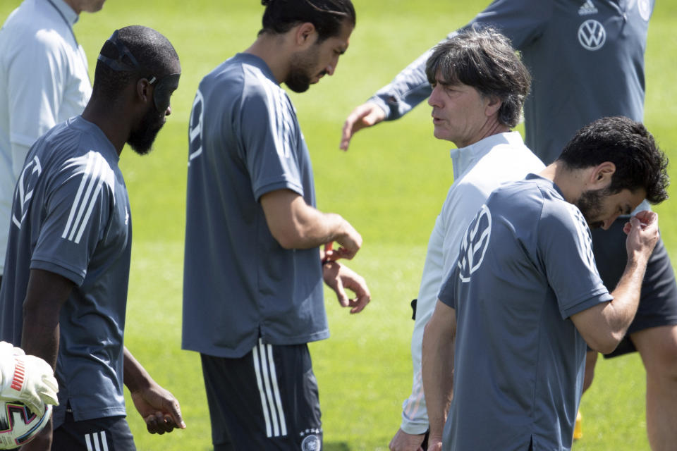 National coach Joachim Low, right, talks to Antonio Rudiger, left, during a team training session for Euro 2020 at the Adi Dassler sports ground in Herzogenaurach, Germany, Sunday June 13, 2021. Germany are scheduled to play France on Tuesday June 15, in Group F of the Euro 2020 soccer championship. (Federico Gambarini/dpa via AP)