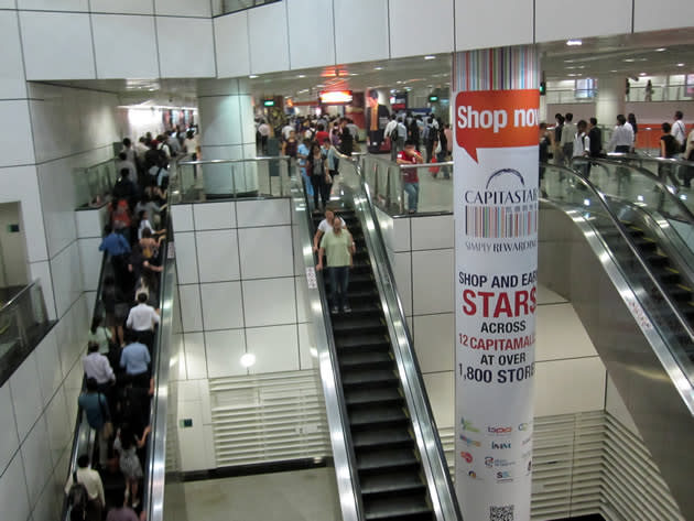 Escalators leading toward Dhoby Ghaut's North East Line station were significantly emptier than the ones headed upward to the North-South Line. (Yahoo! photo/Jeanette Tan)