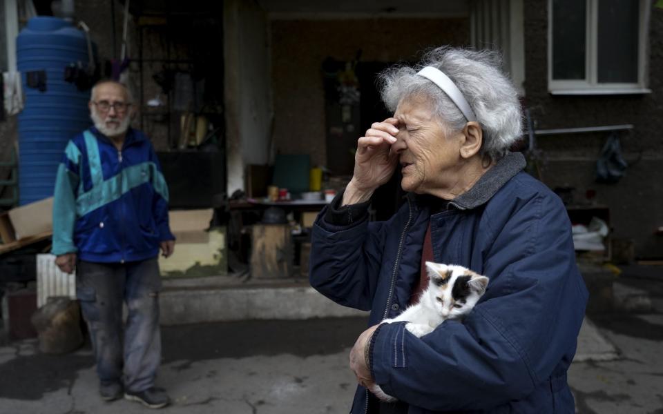 A woman, holding her cat, despairs as clashes continue in Mariupol, Donetsk Oblast - Stringer/Anadolu Agency via Getty Images