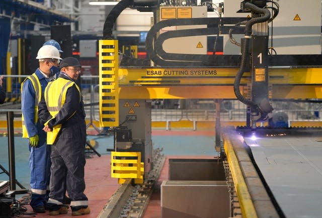 Workers watch a frigate steel cutting ceremony for the first of the class Type 31 frigate, at Babcock Rosyth, Fife