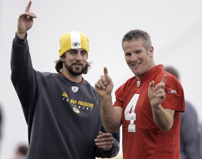 FILE - Green Bay Packers quarterbacks Aaron Rodgers, left, and Brett Favre talk during NFL football practice in Green Bay, Wis., Jan. 16, 2008. The Packers have benefited from three decades of Hall of Fame-caliber quarterback production from Brett Favre and Aaron Rodgers. That's quite the standard for 2020 first-round draft pick Jordan Love to meet. (AP Photo/Morry Gash, File)