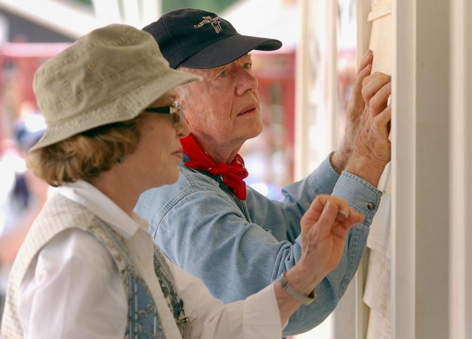 PHOTO: Former President Jimmy Carter and his wife Rosalyn attach siding to the front of a Habitat for Humanity home being built in LaGrange, Ga., June 10, 2003. (Erik S. Lesser/Getty Images)