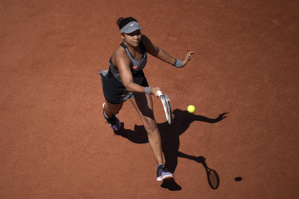 Japan's Naomi Osaka returns the ball to Romania's Patricia Maria Tig during their first round match at the Roland Garros stadium Sunday, May 30, 2021 in Paris. (AP Photo/Christophe Ena)