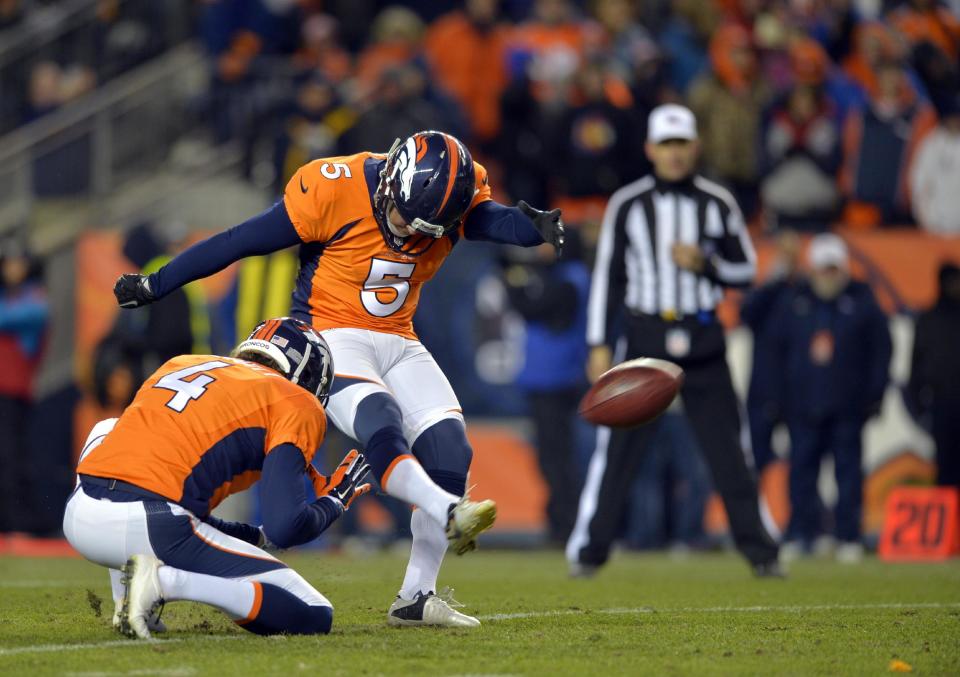 FILE - In this Jan. 12, 2014, file photo, Denver Broncos kicker Matt Prater (5) kicks an extra point as Broncos punter Britton Colquitt (4) holds during the fourth quarter of an AFC divisional playoff NFL football game against the San Diego Chargers in Denver. NFL Commissions Roger Goodell doesn't want to stand pat with the PAT. He's suggesting potential changes in the extra point that, well, might have some legs.(AP Photo/Jack Dempsey, File)