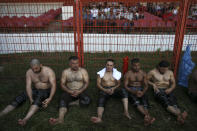 Exhausted wrestlers rest after they competed on the second day of the 660th instalment of the annual Historic Kirkpinar Oil Wrestling championship, in Edirne, northwestern Turkey, Saturday, July 10, 2021.Thousands of Turkish wrestling fans flocked to the country's Greek border province to watch the championship of the sport that dates to the 14th century, after last year's contest was cancelled due to the coronavirus pandemic. The festival, one of the world's oldest wrestling events, was listed as an intangible cultural heritage event by UNESCO in 2010. (AP Photo/Emrah Gurel)