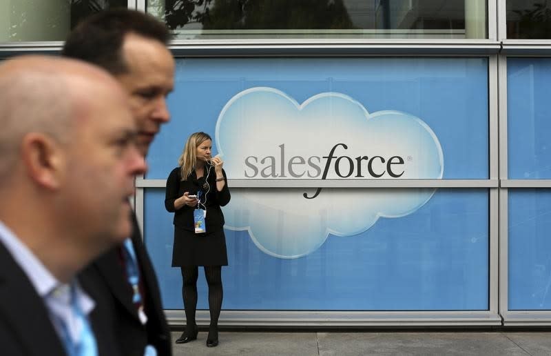 A woman stands near a Salesforce sign during the company's annual Dreamforce event, in San Francisco, California November 18, 2013. REUTERS/Robert Galbraith