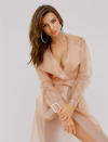 <p>Emily Ratajkowski wears the large jelly hoops in turquoise and a transparent trench coat for the Loucite by Alison Lou campaign. (Photo: Jacqueline Harriet / courtesy of Alison Lou) </p>