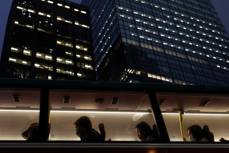 A double-decker bus passes through the Central Financial District, in Hong Kong