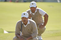 K.H. Lee, of South Korea, and Tom Kim, of South Korea, line up a putt on the 12th green during their foursomes match at the Presidents Cup golf tournament at the Quail Hollow Club, Saturday, Sept. 24, 2022, in Charlotte, N.C. (AP Photo/Chris Carlson)