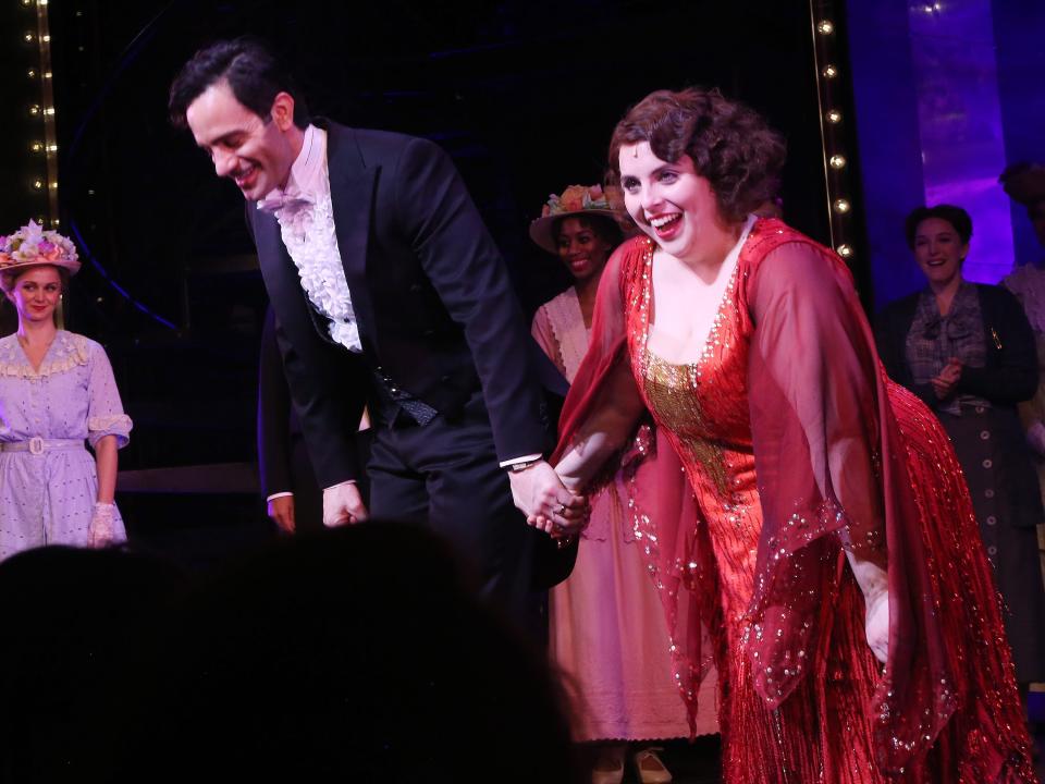 Ramin Karimloo, in a tuxedo, and Beanie Feldstein, in a sparkly red dress, take a bow during the curtain call for a preview performance of the Broadway musical "Funny Girl."