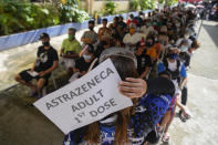 Residents wait to be inoculated with COVID-19 vaccines at a school during the first day of a nationwide three-day vaccination drive in Quezon city, Philippines on Monday, Nov. 29, 2021. The emergence of the new omicron variant and the world’s desperate and likely futile attempts to keep it at bay are reminders of what scientists have warned for months: The coronavirus will thrive as long as vast parts of the world lack vaccines. (AP Photo/Aaron Favila)