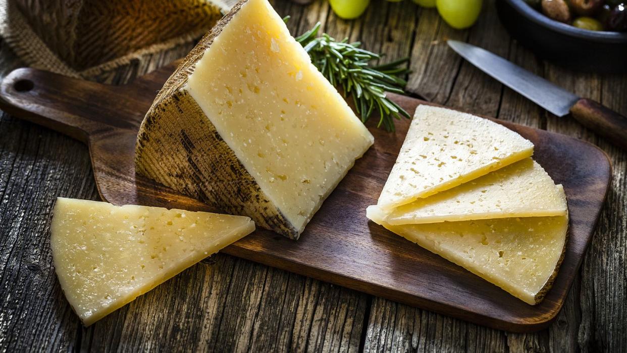 spanish food manchego cheese on rustic wooden table