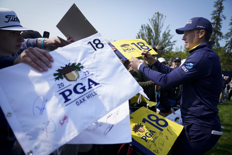 Jordan Spieth signs autographs during a practice round for the PGA Championship golf tournament at Oak Hill Country Club on Wednesday, May 17, 2023, in Pittsford, N.Y. (AP Photo/Seth Wenig)