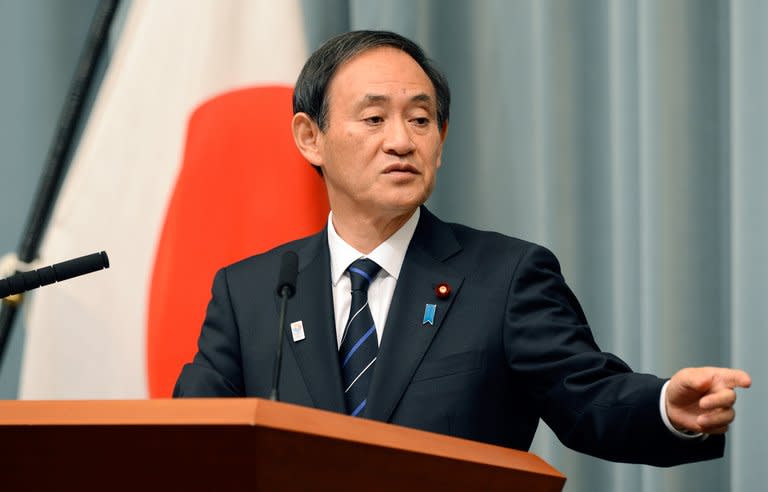 Japan's Chief Cabinet Secretary Yoshihide Suga answers questions during a press conference in Tokyo, on January 21, 2013. Suga on Wednesday declared himself dumbfounded after a recent prime minister said he understood China's claim to islands at the centre of a bitter row between Tokyo and Beijing