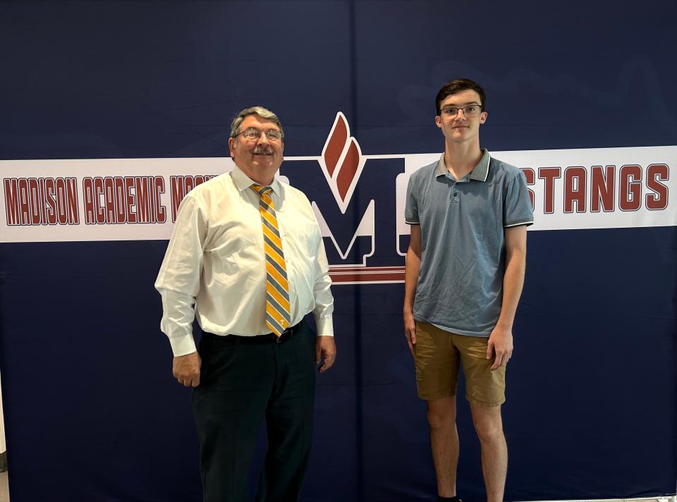 Computer applications teacher Garry Carroll (left) poses for a picture with his student and Microsoft Office state champion Samuel Latham (right) at Madison Academic High School in Jackson, Tenn. on June 20, 2023.