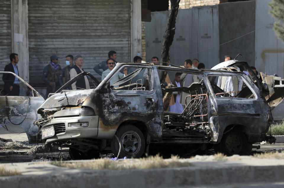 FILE - In this June 12, 2021 file photo, Afghan security personnel inspect the site of a bomb explosion in Kabul, Afghanistan. In a report released Monday, July 26, 2021, the United Nations said that more women and children were killed and wounded in Afghanistan in the first half of 2021 than in any year since the UN began keeping count in 2009. (AP Photo/Rahmat Gul, File)