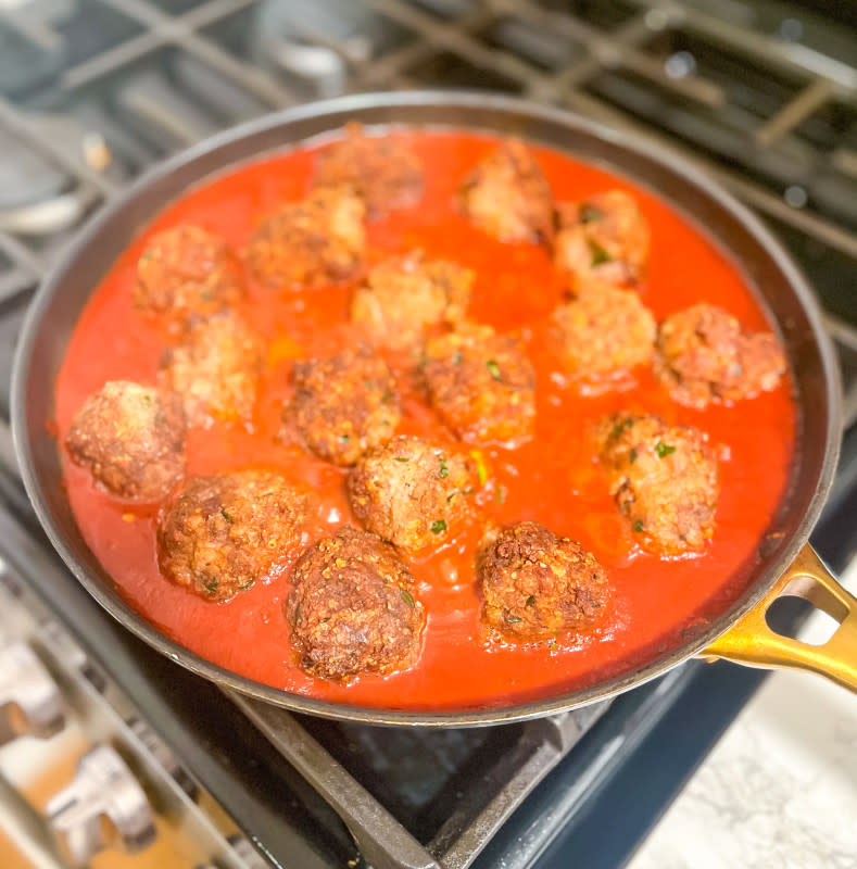Meatballs simmering in sauce<p>Courtesy of Jessica Wrubel</p>