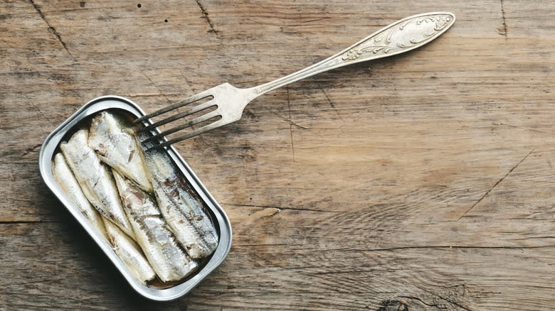 canned sardines with fork