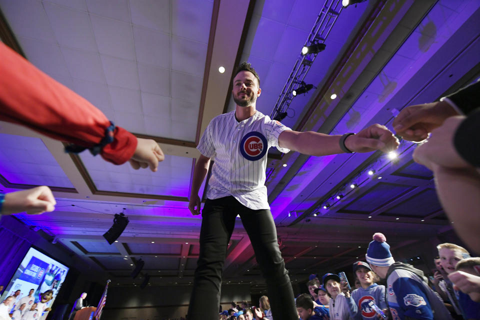 Chicago Cubs' Kris Bryant fist-bumps fans after being announced during the baseball team's convention Friday, Jan. 17, 2020, in Chicago. (AP Photo/Paul Beaty)