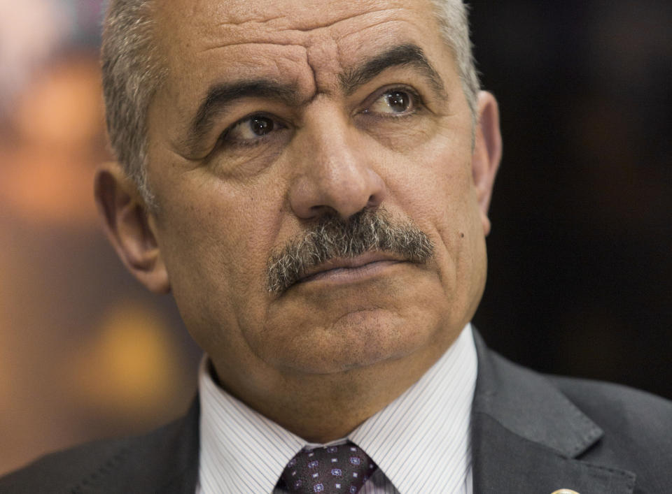 Palestinian Prime Minister Mohammad Shtayyeh listens during an interview with The Associated Press, at his office in the West Bank city of Ramallah, Tuesday, April 16, 2019. Stayyeh accused the United States of declaring "financial war" on his people and said an American peace plan purported to be in the works will be "born dead." (AP Photo/Nasser Nasser)