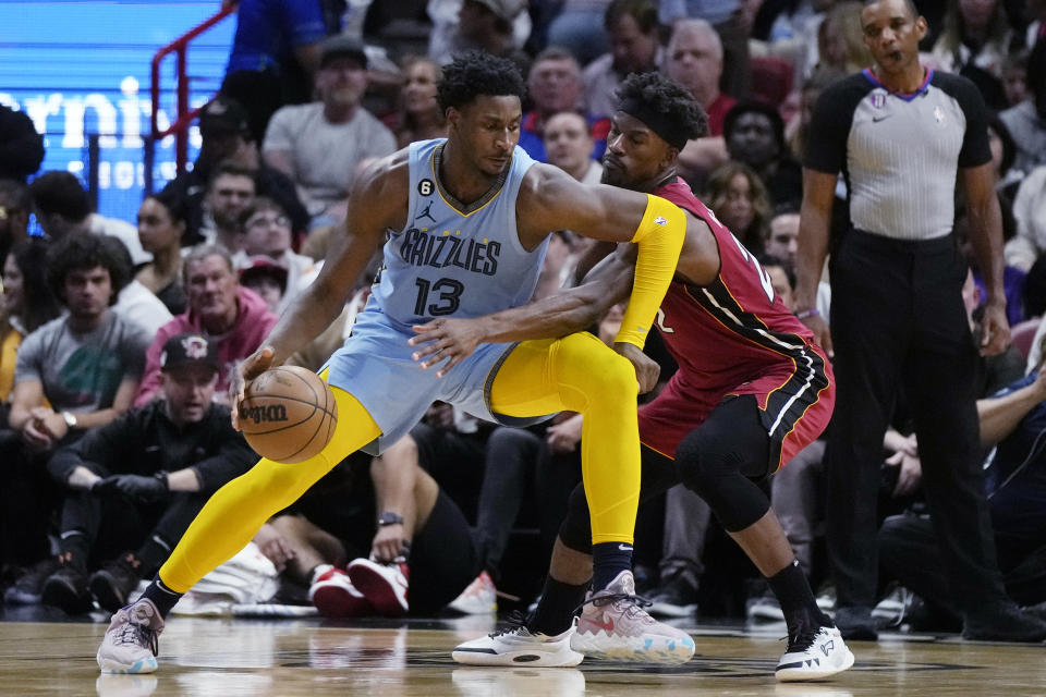 Memphis Grizzlies forward Jaren Jackson Jr. (13) works to get past Miami Heat forward Jimmy Butler during the first half of an NBA basketball game Wednesday, March 15, 2023, in Miami. (AP Photo/Rebecca Blackwell)