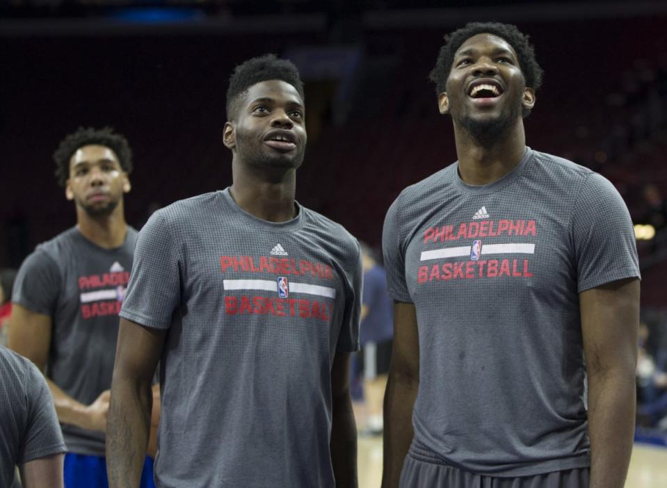 Joel Embiid and Nerlens Noel share a laugh, as Jahlil Okafor ponders the future. (Getty Images)