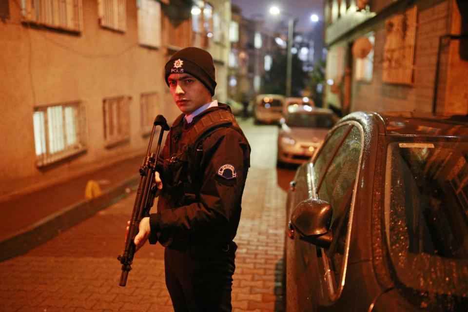 A Turkish police officer secures a road near Istanbul's main police headquarters, Friday, Jan. 20, 2017. A Turkish media report says a rocket-propelled grenade was fired near the headquarters but that it missed the building. There was no further information on the incident, which comes at a time when Turkey has suffered a series of deadly attacks carried out either by the Islamic State group or Kurdish militants.(AP Photo/Emrah Gurel)