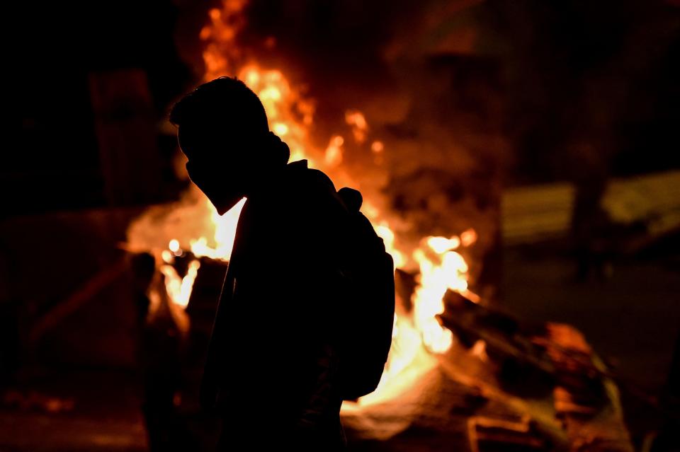 A demonstrator is seen at a barricade blocking a street during a protest against the government in Cali, Colombia, on May 10, 2021.