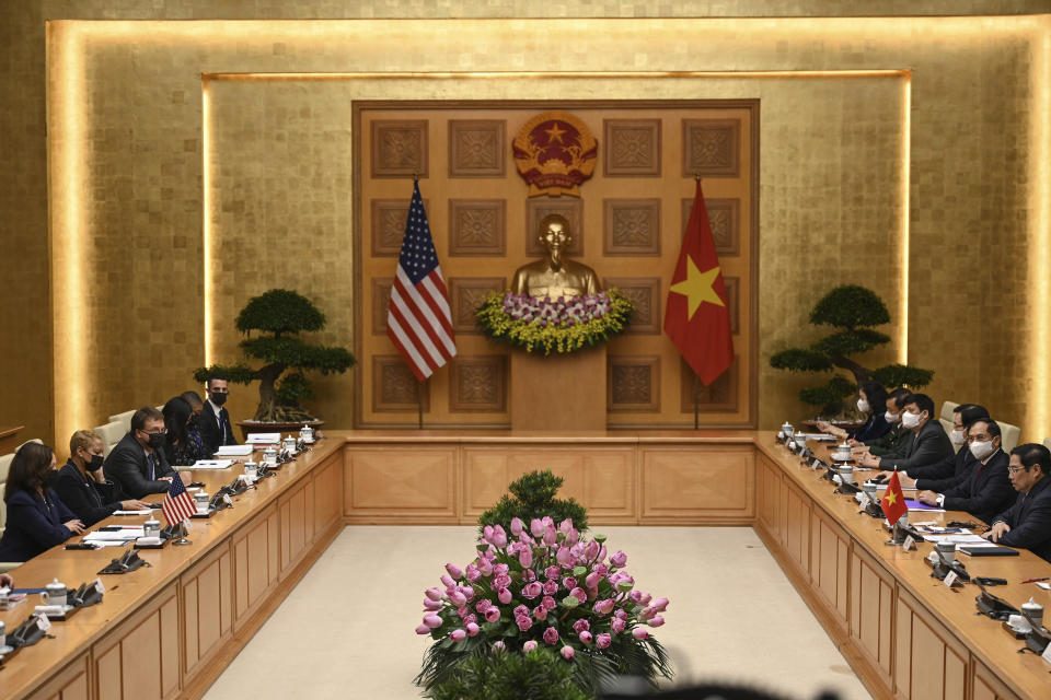 U.S. Vice President Kamala Harris, left, and Vietnamese Prime Minister Pham Minh Chinh, right, attend a meeting at the government office in Hanoi, Vietnam, Wednesday, Aug. 25, 2021. Harris turns her focus to the coronavirus pandemic and global health during her visit to Vietnam, a country grappling with a worsening surge in the virus and stubbornly low vaccination rates. (Manan Vatsyayana/Pool Photo via AP)