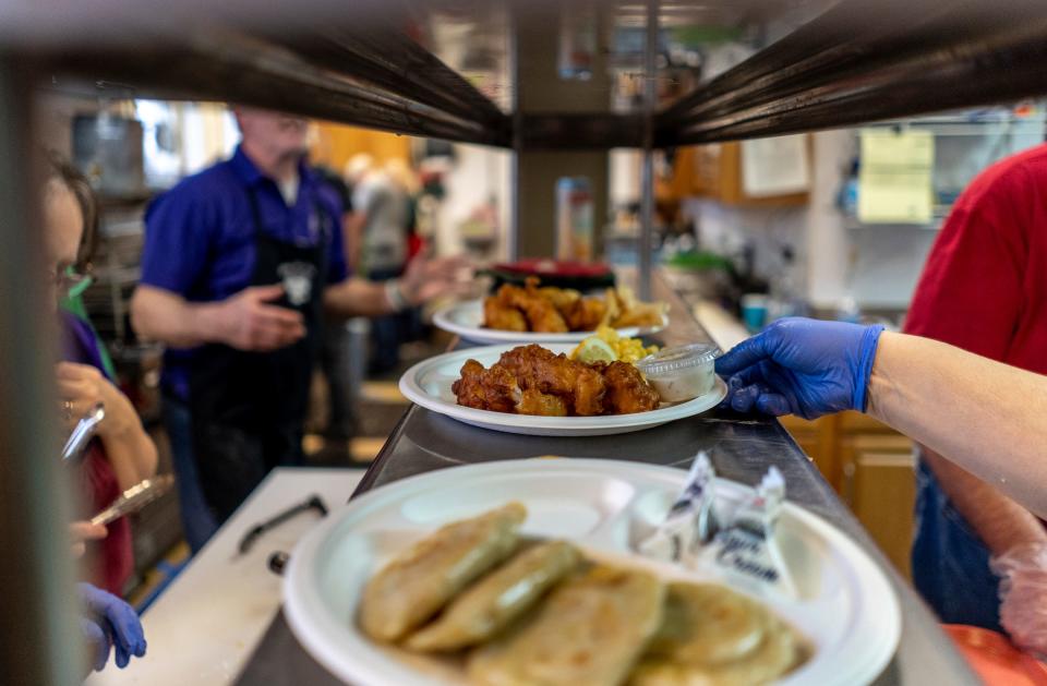 Orders of fried fish are readied for at the Parish Hall of Sweetest Heart of Mary Church in Detroit on Friday, March 17, 2023.