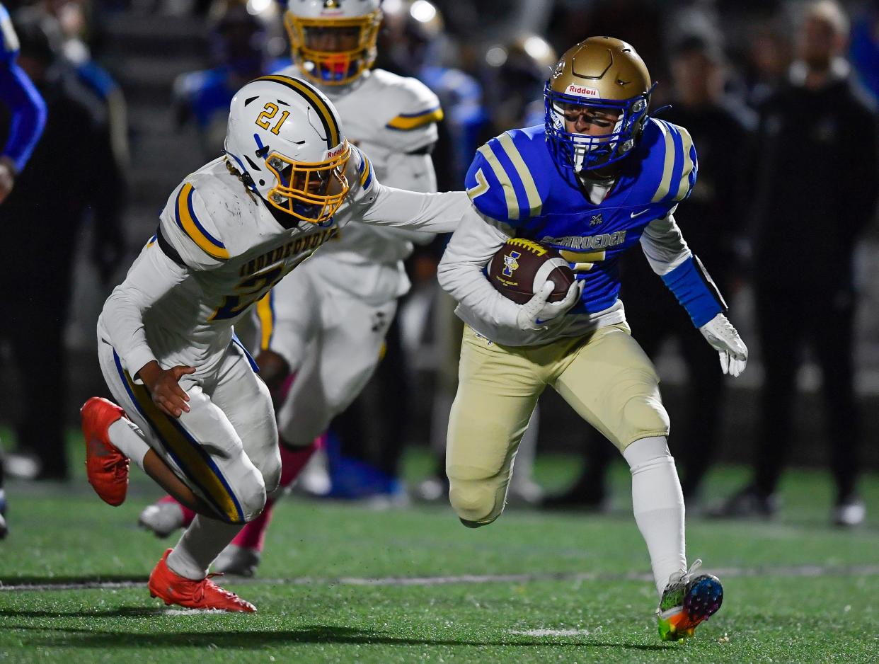 Webster Schroeder's Justin Maier, right, carries the ball away from Irondequoit's Serah Hall during a regular season game, Friday, Oct. 13, 2023.