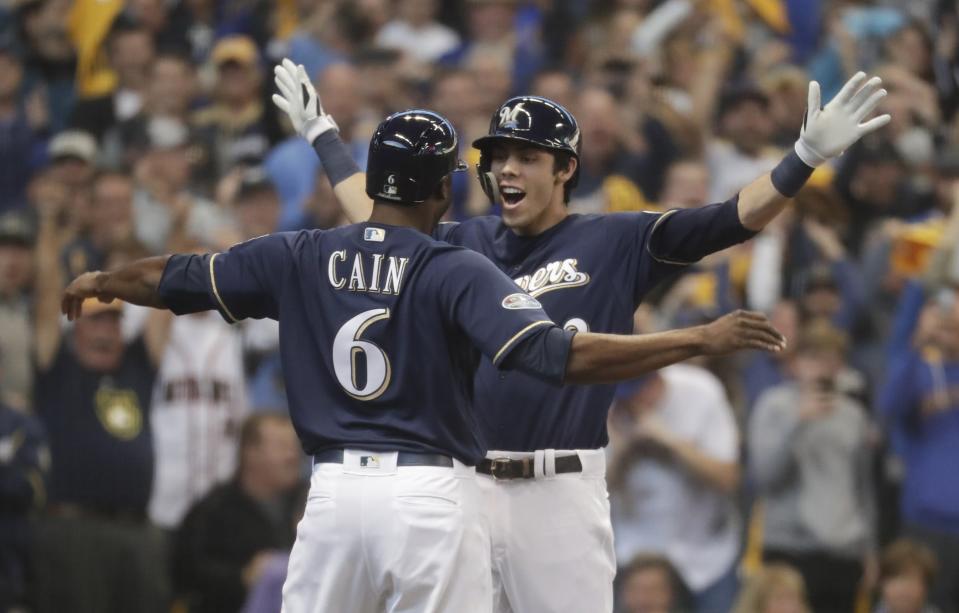 Milwaukee Brewers' Christian Yelich celebrates his two-run home run with Lorenzo Cain during the third inning of Game 1 of the National League Divisional Series baseball game against the Colorado Rockies Thursday, Oct. 4, 2018, in Milwaukee. (AP Photo/Morry Gash)