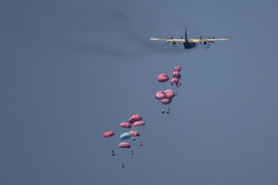 An aircraft airdrops humanitarian aid over northern Gaza Strip, as seen from southern Israel, Wednesday, March 20, 2024. (AP Photo/Leo Correa)