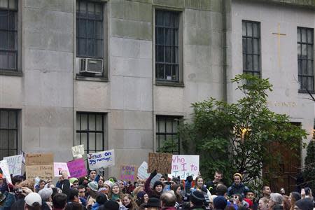 Eastside Catholic High School students are pictured during a rally in support of the school's former Vice Principal Mark Zmuda at the Archdiocese of Seattle chancery building in Seattle, Washington, December 20, 2013. REUTERS/David Ryder