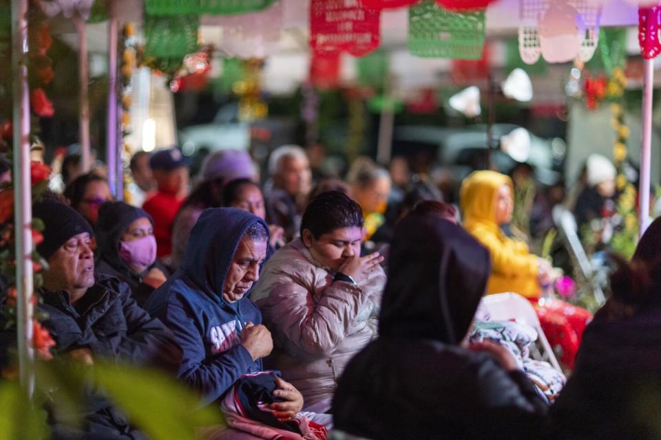 People pray at Luis Enrique Cantabrana's home where he has created a popular shrine in honor of the Virgen de Guadalupe