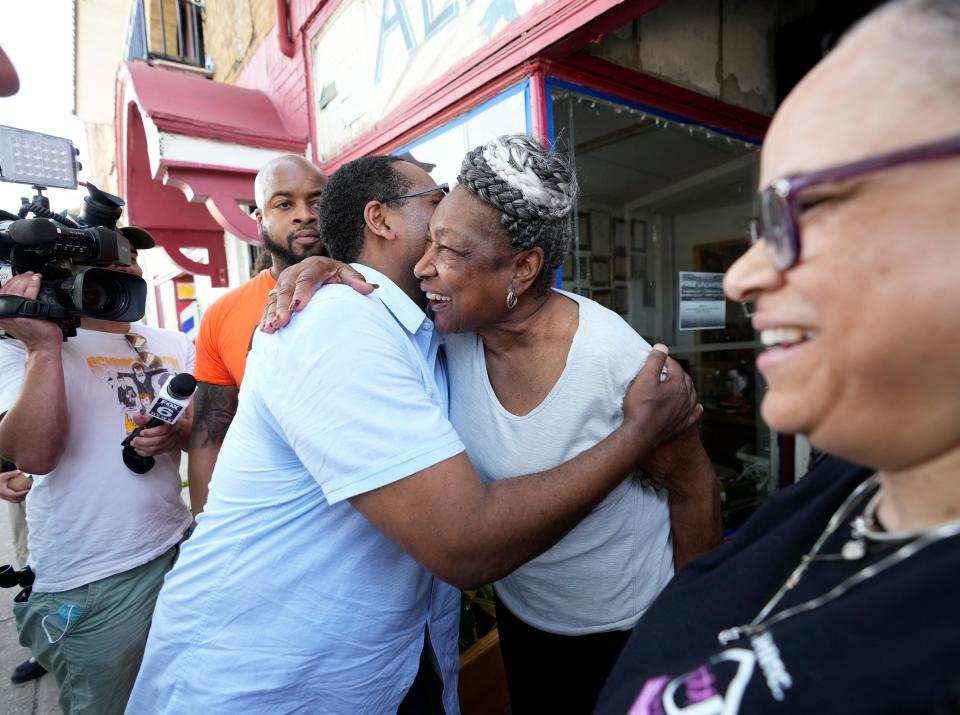 Ald. Ashanti Hamilton, left, hugs Martha “Mama” Freeman outside her Alpha Omega Ministry on North 27th Street in Milwaukee on June 15. Gov. Tony Evers joined community leaders on a walk through the Garden Homes neighborhood while discussing safety and gun violence prevention initiatives.