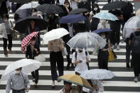 People wearing protective face masks to help curb the spread of the coronavirus walk at a pedestrian crossing Friday, July 10, 2020, in Tokyo. The Japanese capital has confirmed more than 240 new coronavirus infections on Friday, exceeding its previous record. (AP Photo/Eugene Hoshiko)