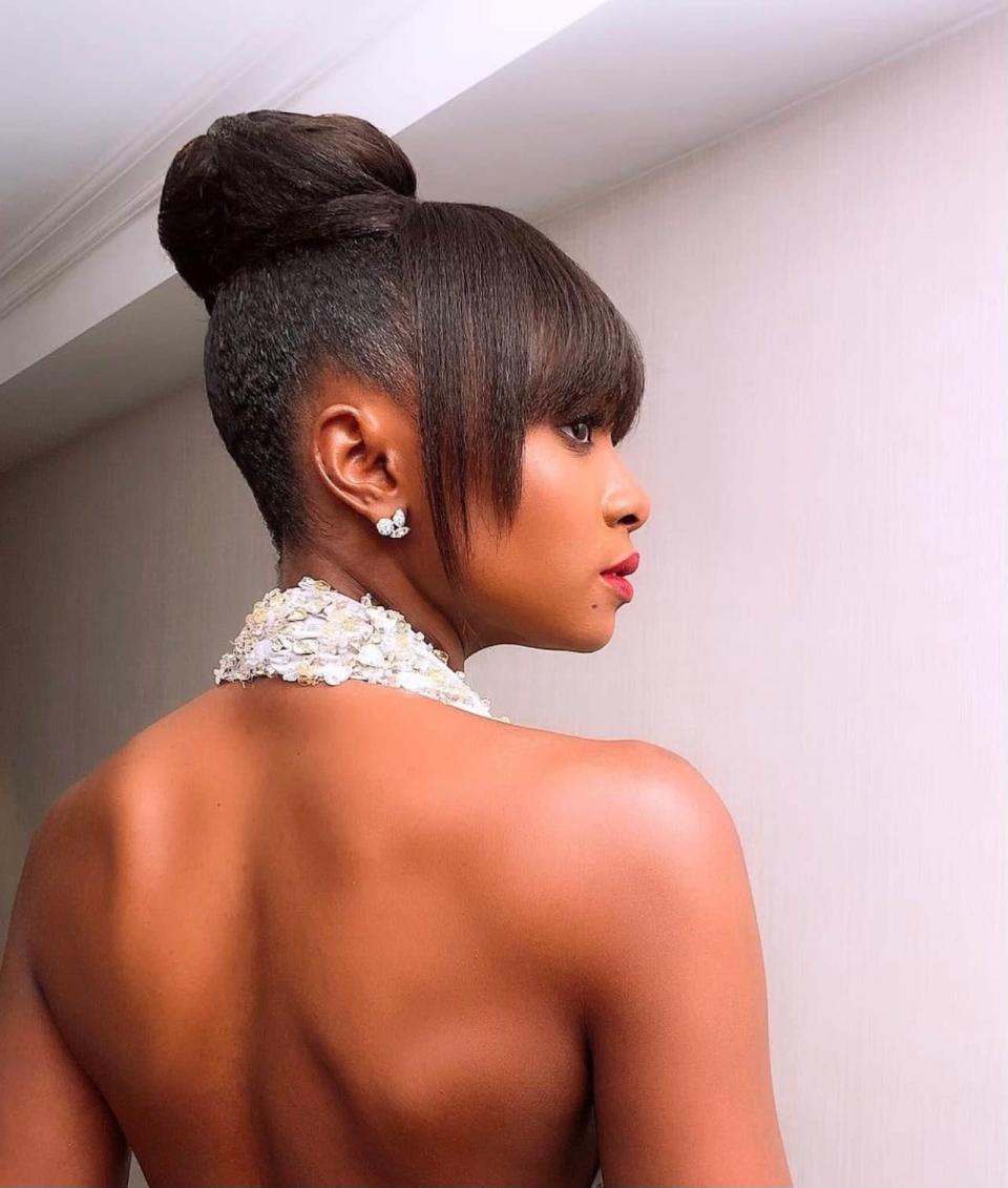 Add a sleek, sculptural aesthetic to your updo with clean lines and contrasting shapes. “There are so many great variations of an updo that you can take,” says Redway. Take inspiration from the silhouette of your outfit to guide the shape, and build your base with plenty of <a href="https://shop-links.co/chEW82TRYig" rel="nofollow noopener" target="_blank" data-ylk="slk:Tresemmé One Step Style Smooth Cream" class="link ">Tresemmé One Step Style Smooth Cream</a>. If you want an especially sleek finish, squeeze a little hair gel on your fingers and run them over your hair to keep everything in place.